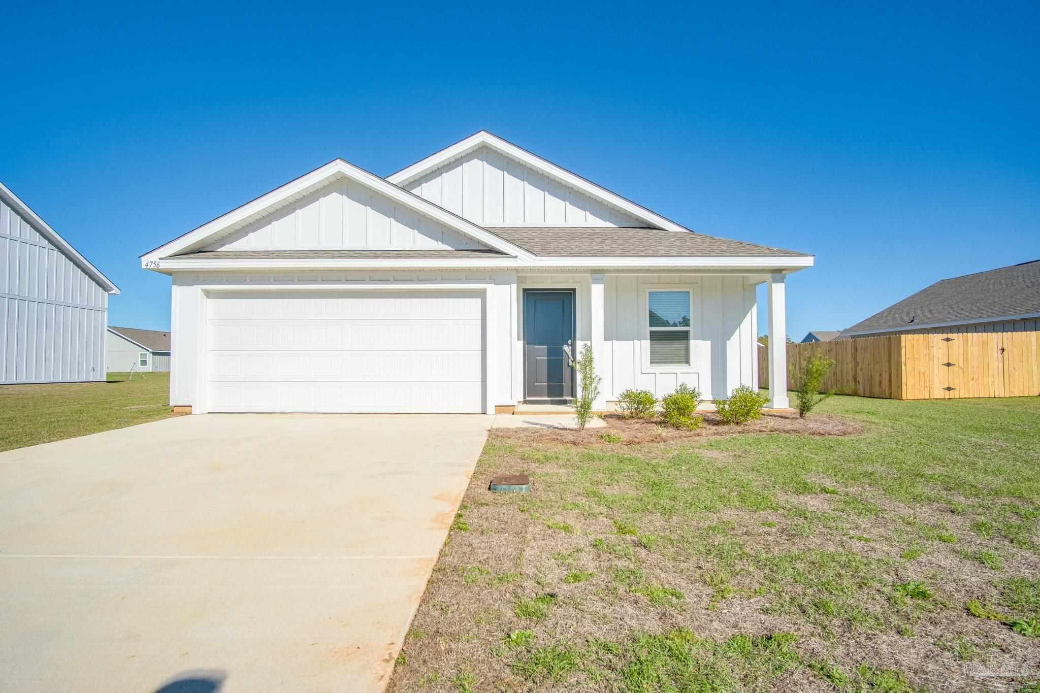 a front view of a house with yard and garage