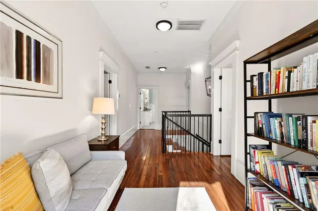 a spacious bedroom with a bed a flat screen tv and a table