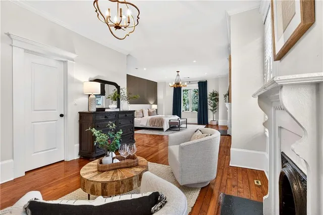 a living room with couches a flat screen tv and a fireplace