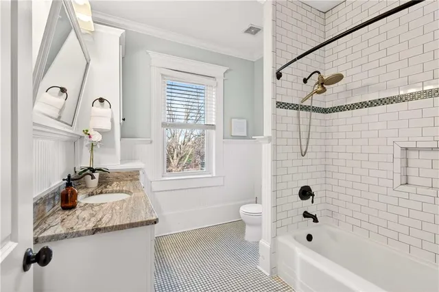 a bathroom with a sink vanity granite and a mirror