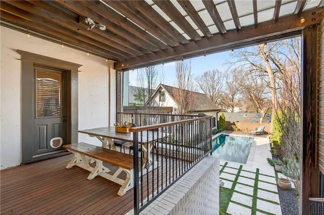a view of house with swimming pool and sitting area