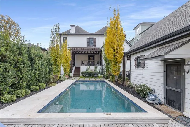 a bathroom with a sink a toilet a mirror and shower