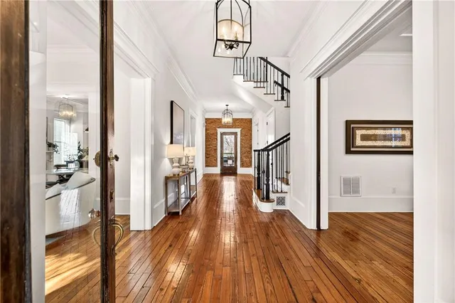 a view of a hallway with wooden floor windows and livingroom