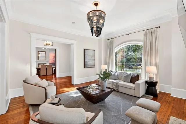 a living room with furniture or couch and a chandelier