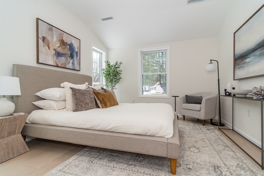 5 Launcher Way Wayland, MA 01778 - Photo 17 of 17 a bedroom with a large bed couch and two windows