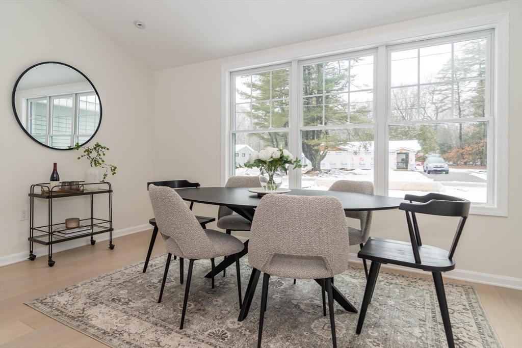 5 Launcher Way Wayland, MA 01778 - Photo 9 of 17 a dining room with furniture and a mirror