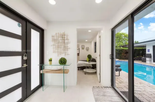 a living room with furniture and a floor to ceiling window