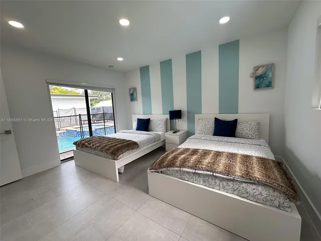 a spacious bedroom with a large bed and a large window