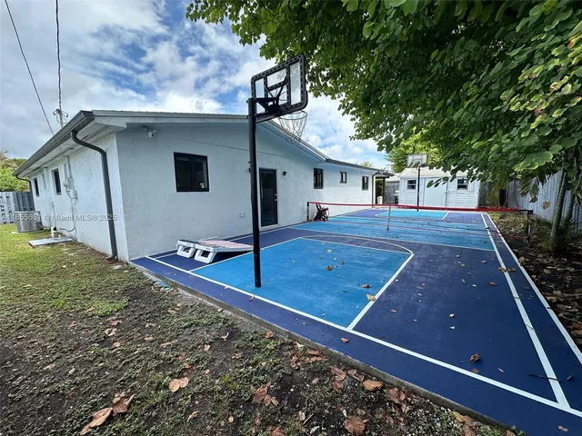 a view of a backyard with a large tree