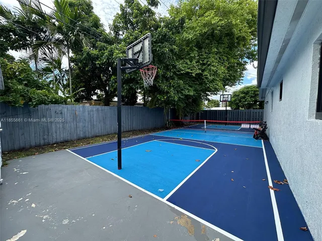 a view of a tennis court with a large tree