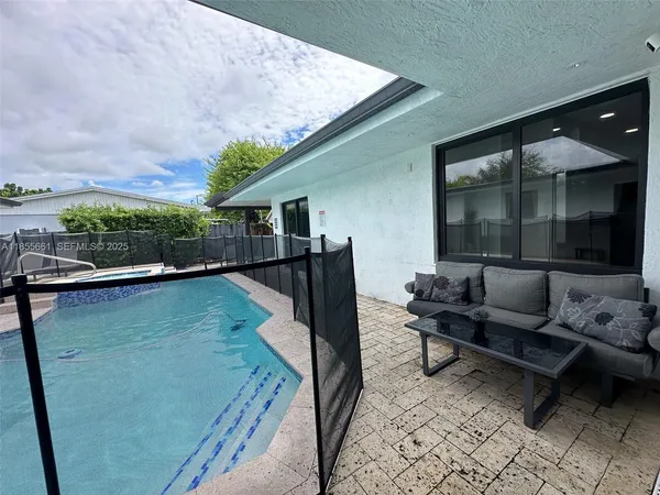 a balcony with furniture and a potted plant