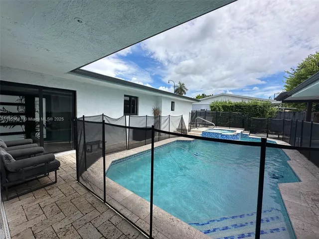 a view of swimming pool with seating space