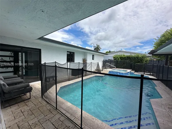a view of swimming pool with seating space