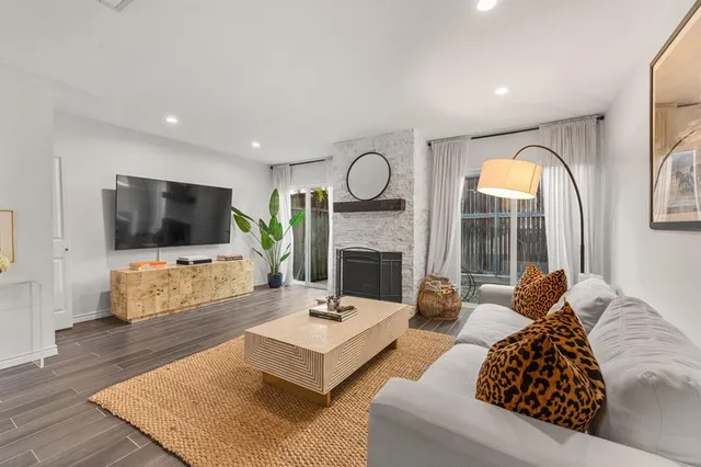 a living room with fireplace furniture and a flat screen tv