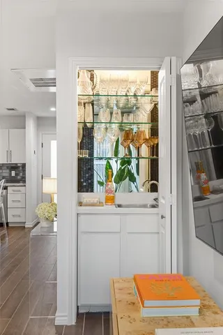 a living room with a floor to ceiling window and wooden floor
