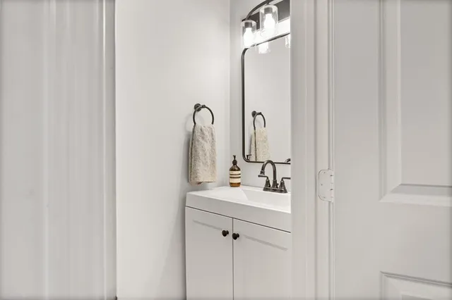 a bathroom with a double vanity sink and a mirror
