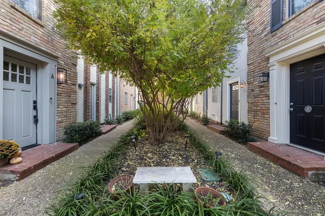a view of backyard of house with green space