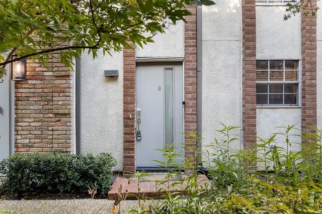 a couple of potted plants in front of door