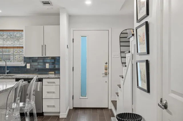 a kitchen with stainless steel appliances a refrigerator and cabinets