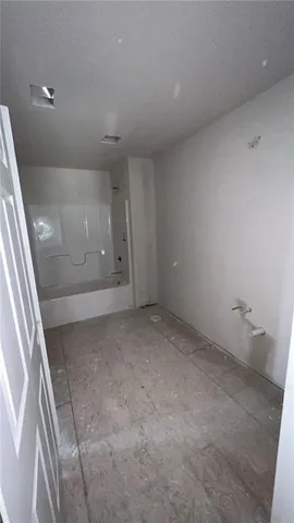 a view of an empty room with glass door