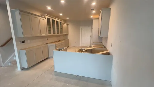 a kitchen with stainless steel appliances granite countertop a sink and a refrigerator