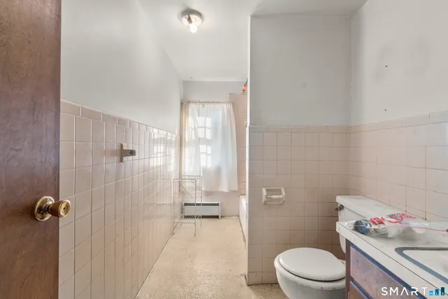 a bathroom with a toilet a sink and shower