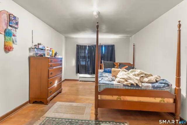 a bedroom with a bed and a dresser