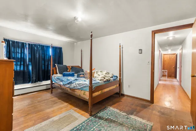 a bedroom with a bed and a view of bathroom