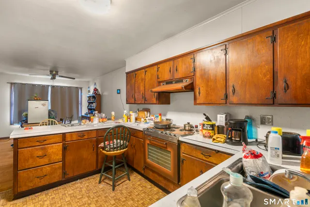 a kitchen with a sink stove and cabinets