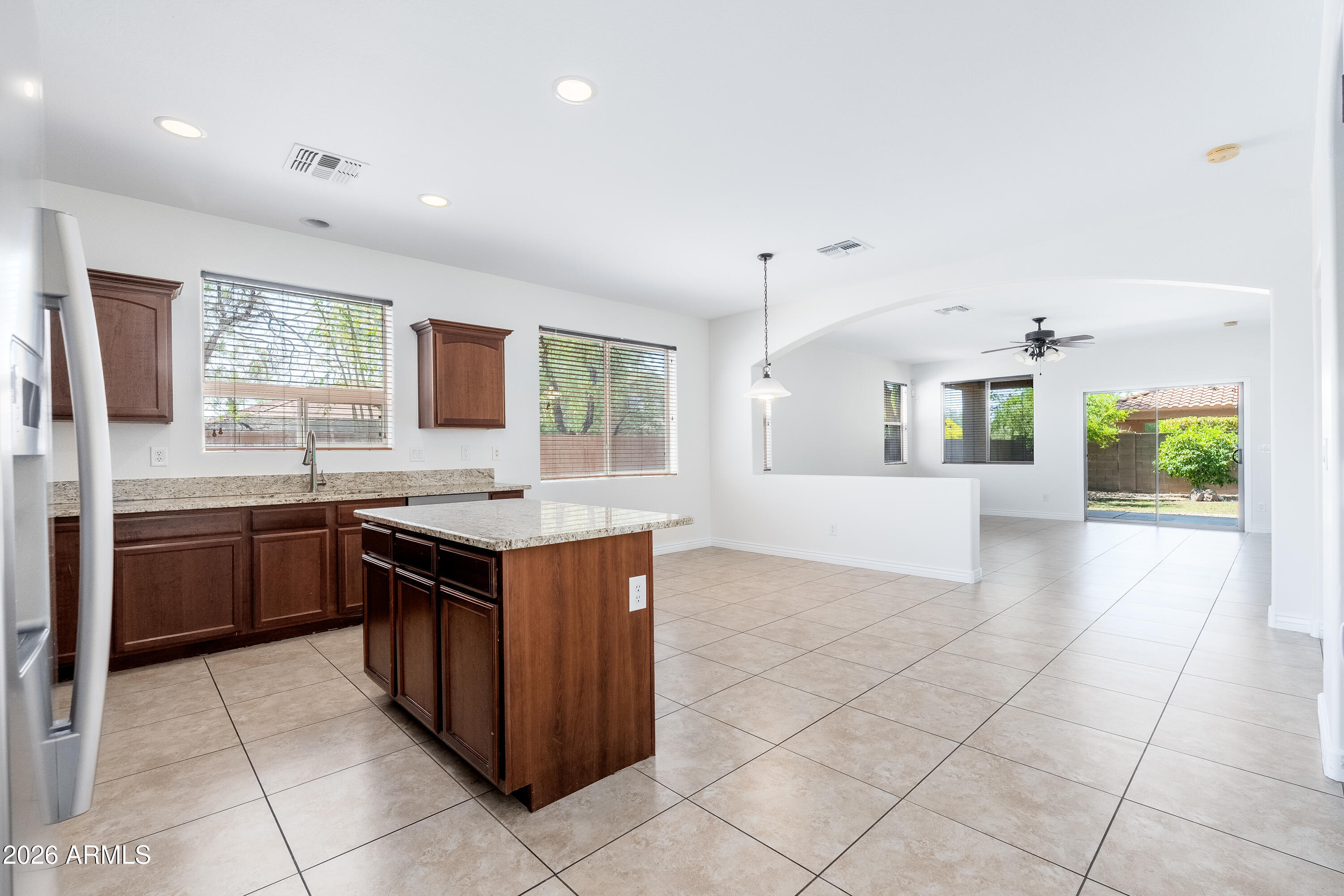 4317 East Folgers Road Phoenix, AZ 85050 - Photo 12 of 40 a kitchen with stainless steel appliances granite countertop a stove a sink and a microwave