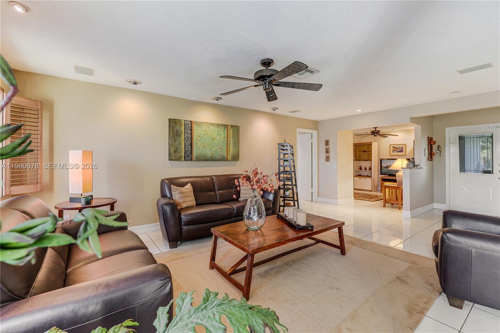 14952 Southwest 149th Street Miami, FL 33196 - Photo 13 of 64 a living room with furniture and a flat screen tv