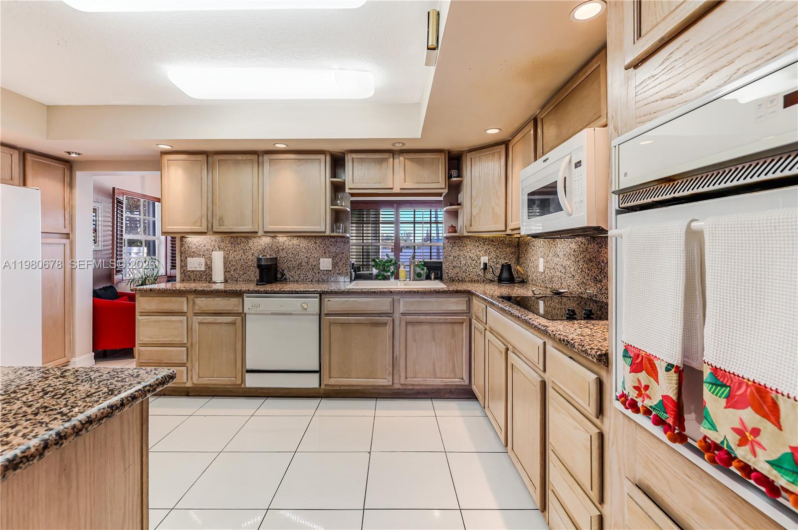 14952 Southwest 149th Street Miami, FL 33196 - Photo 19 of 64 a kitchen with stainless steel appliances granite countertop a refrigerator and a stove