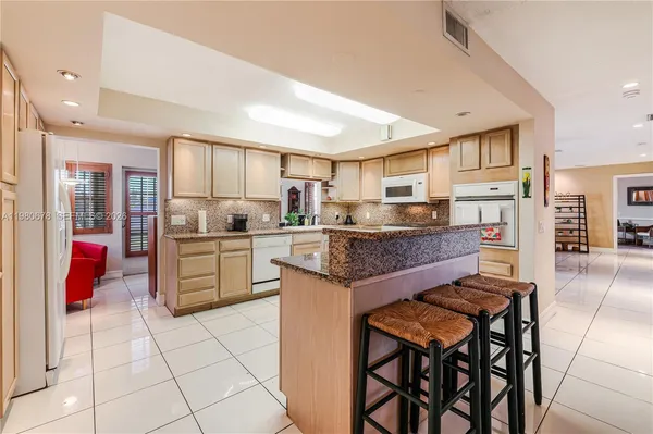 a kitchen that has a lot of cabinets a sink and a wooden floor in it