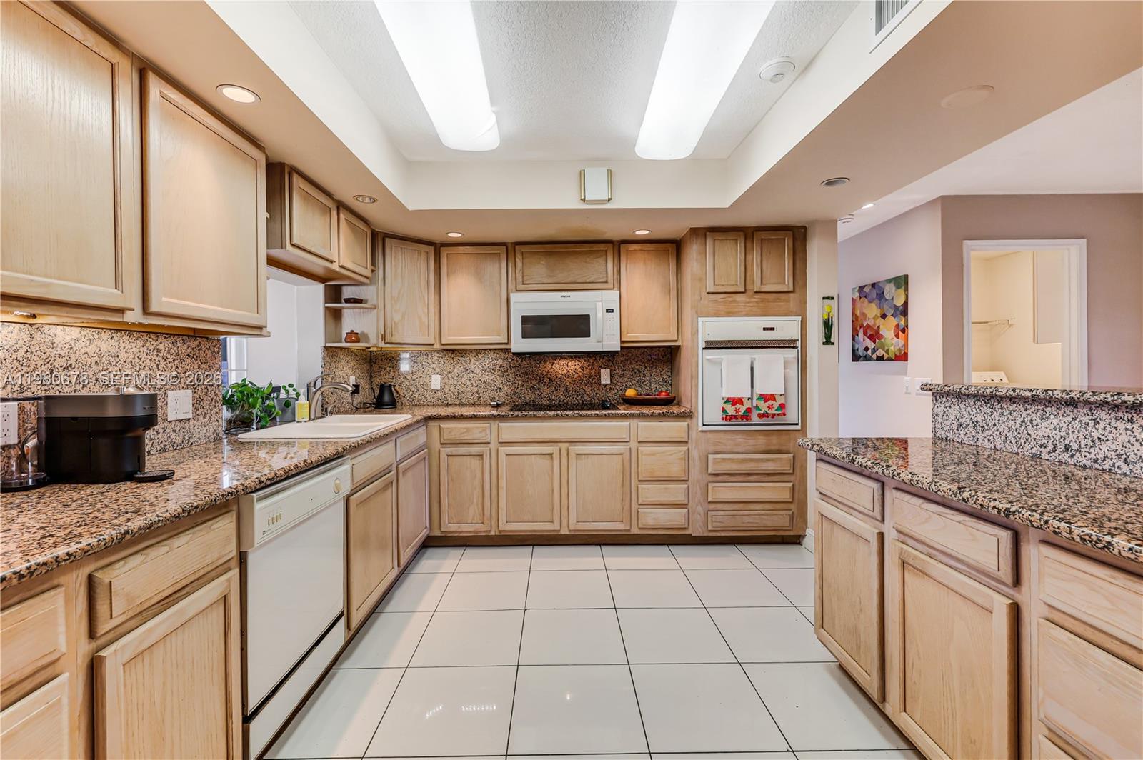 14952 Southwest 149th Street Miami, FL 33196 - Photo 21 of 64 a kitchen with stainless steel appliances granite countertop a sink and cabinets