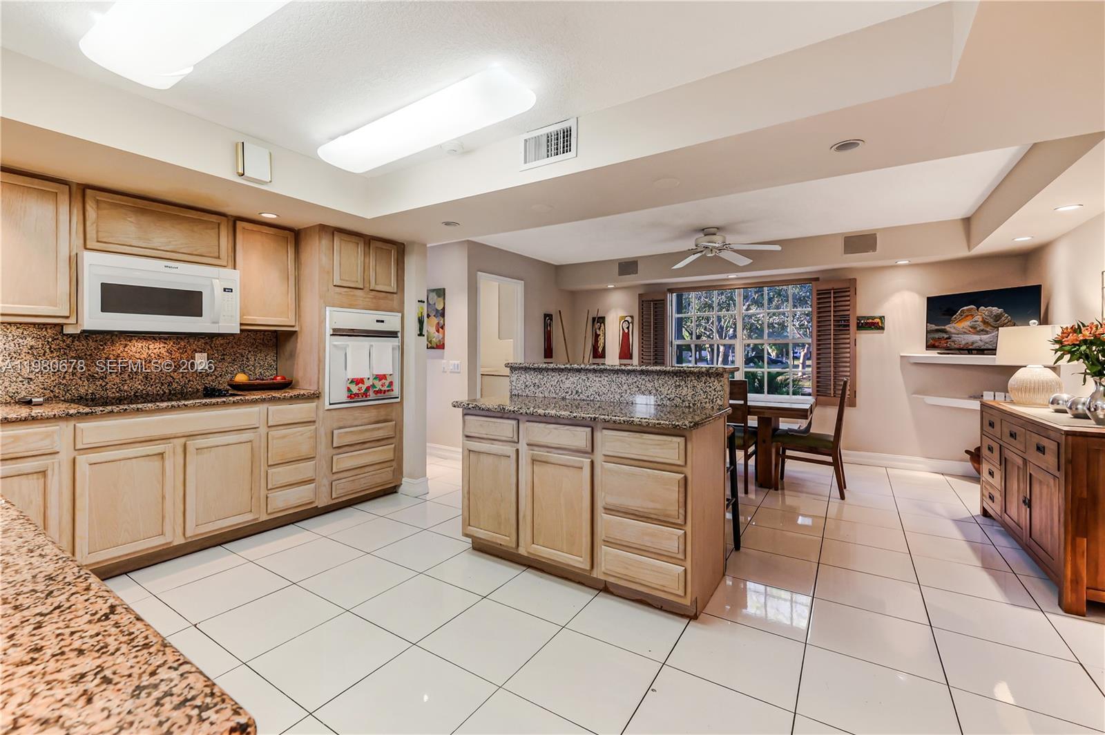 14952 Southwest 149th Street Miami, FL 33196 - Photo 22 of 64 a kitchen with granite countertop cabinets and steel appliances