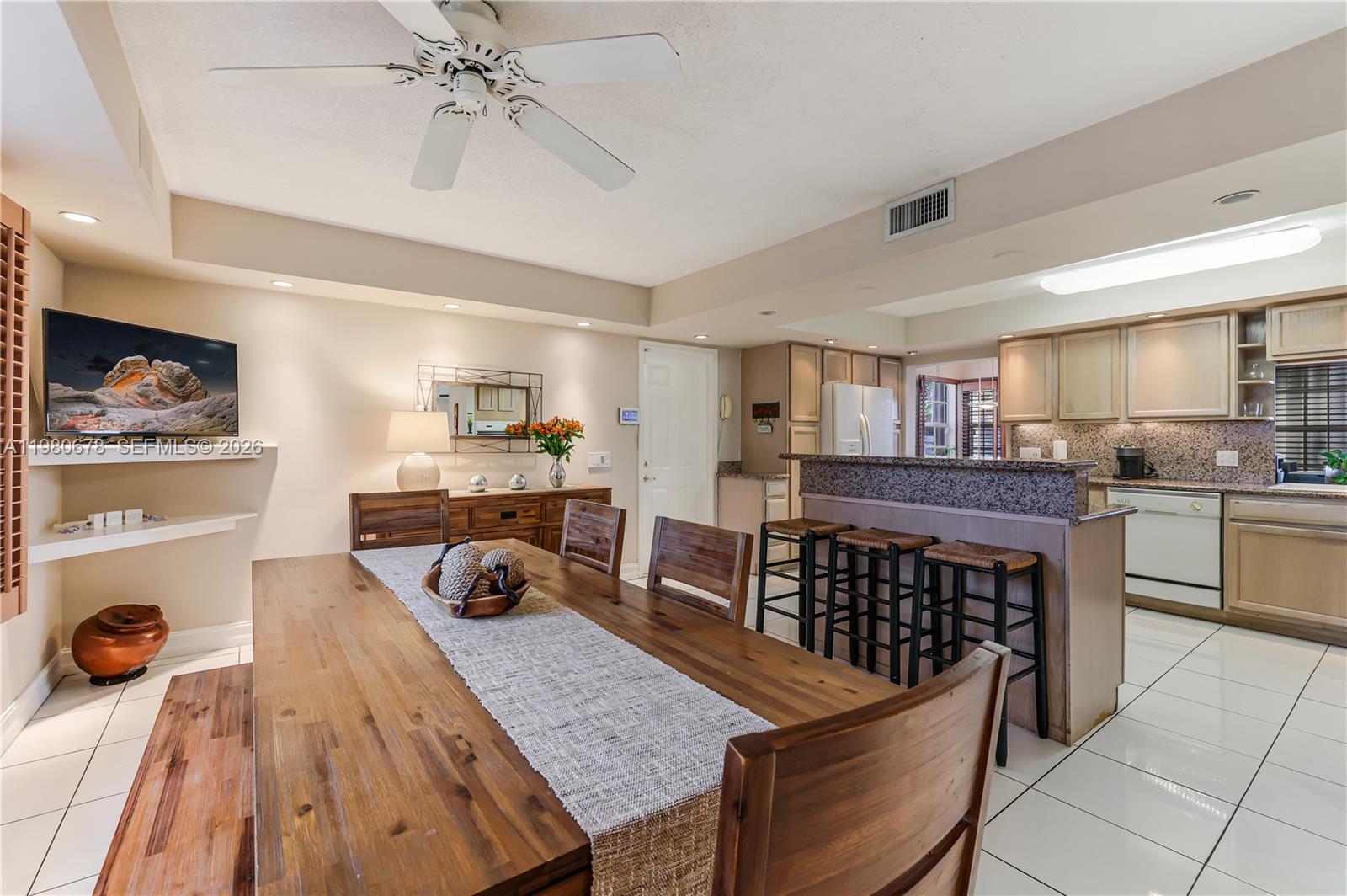 14952 Southwest 149th Street Miami, FL 33196 - Photo 25 of 64 a kitchen that has a lot of cabinets a sink and a wooden floor in it