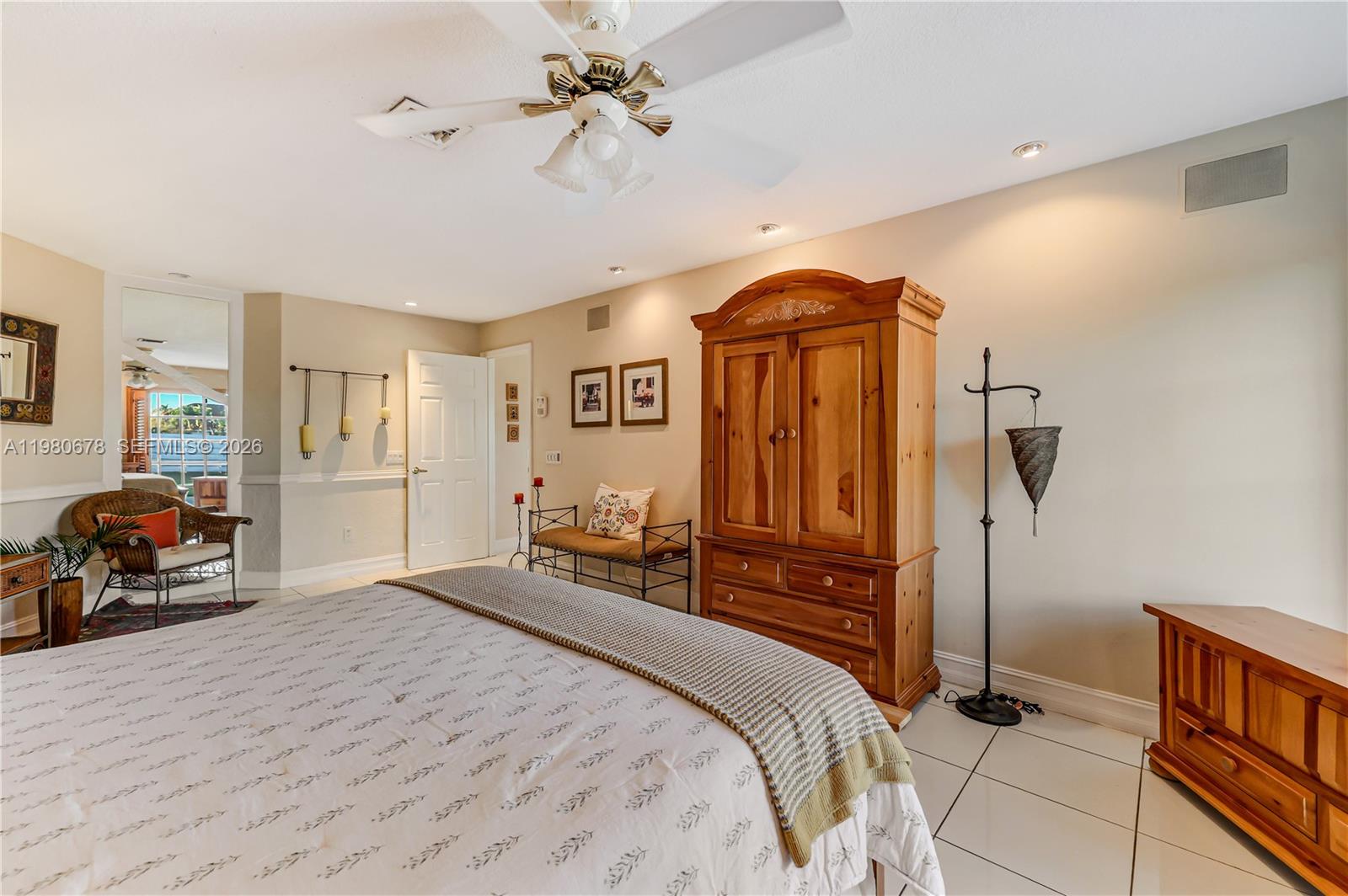 14952 Southwest 149th Street Miami, FL 33196 - Photo 29 of 64 a bedroom with a bed and a chandelier