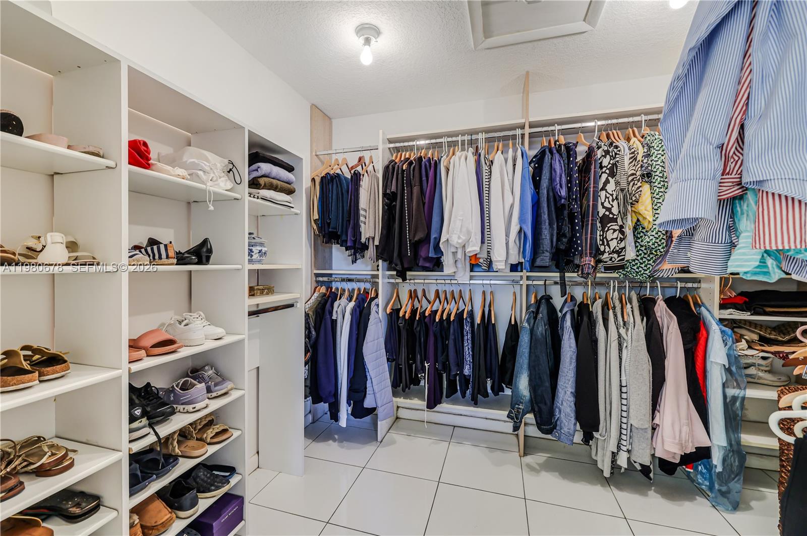 14952 Southwest 149th Street Miami, FL 33196 - Photo 32 of 64 a view of walk in closet with clothes and shoes