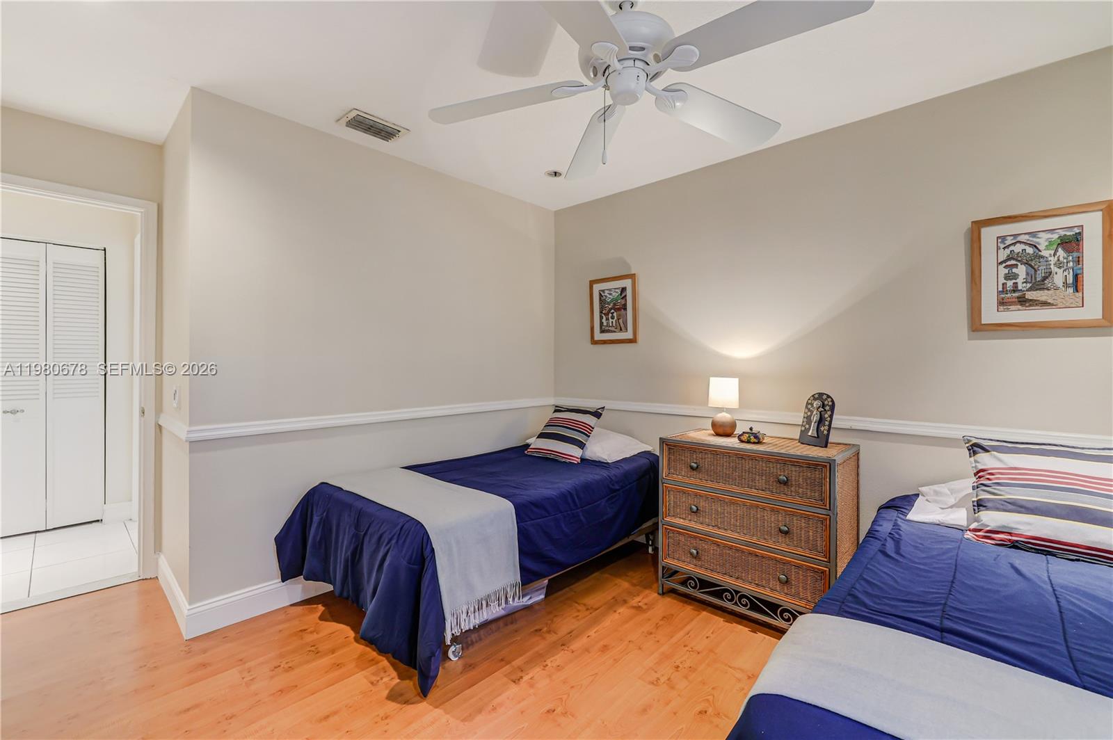 14952 Southwest 149th Street Miami, FL 33196 - Photo 36 of 64 a bedroom with a bed and a chandelier