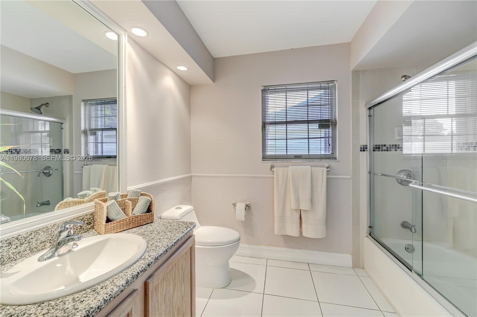 14952 Southwest 149th Street Miami, FL 33196 - Photo 37 of 64 a spacious bathroom with a granite countertop sink a toilet and shower