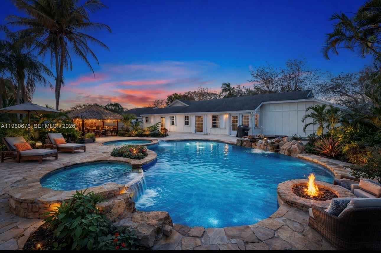14952 Southwest 149th Street Miami, FL 33196 - Photo 41 of 64 a view of a swimming pool with lounge chairs