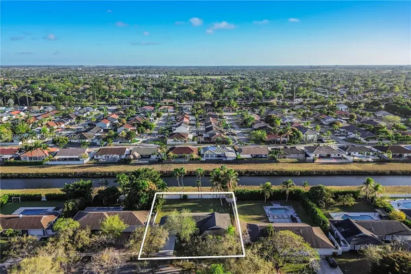 an aerial view of a house with outdoor space and street view