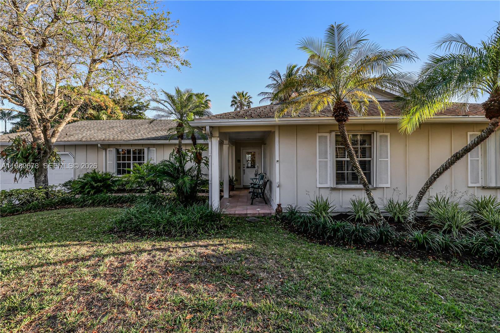 14952 Southwest 149th Street Miami, FL 33196 - Photo 6 of 64 a front view of a house with a garden