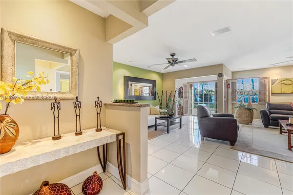 a living room with furniture and a view of kitchen