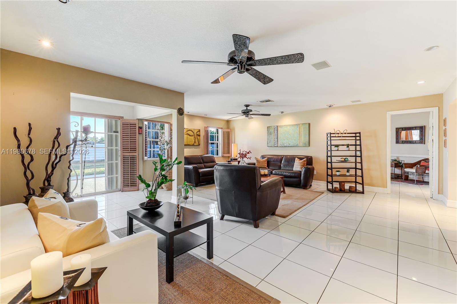 14952 Southwest 149th Street Miami, FL 33196 - Photo 9 of 64 a living room with furniture and a view of kitchen