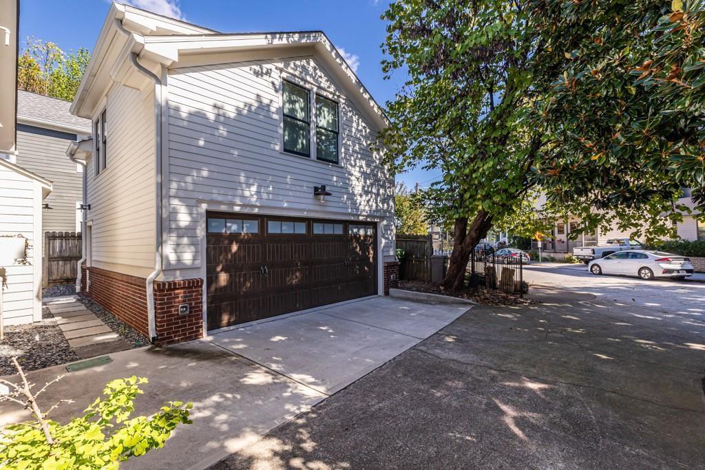69 Randolph Street Northeast, Unit B Atlanta, GA 30312 - Photo 2 of 19 a front view of a house with a yard
