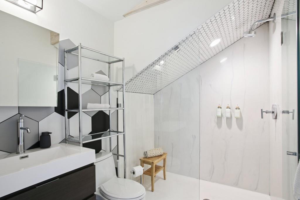 69 Randolph Street Northeast, Unit B Atlanta, GA 30312 - Photo 7 of 19 a bathroom with a sink mirror vanity and toilet
