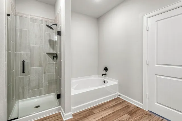 a bathroom with a bathtub and a shower