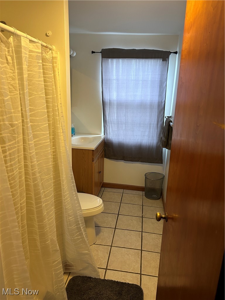 3005 Bardshar Road Sandusky, OH 44870 - Photo 21 of 24 Full bath with tile patterned floors, a shower with curtain, toilet, and vanity