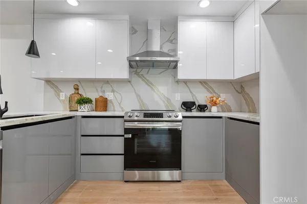 a stove top oven sitting inside of a kitchen